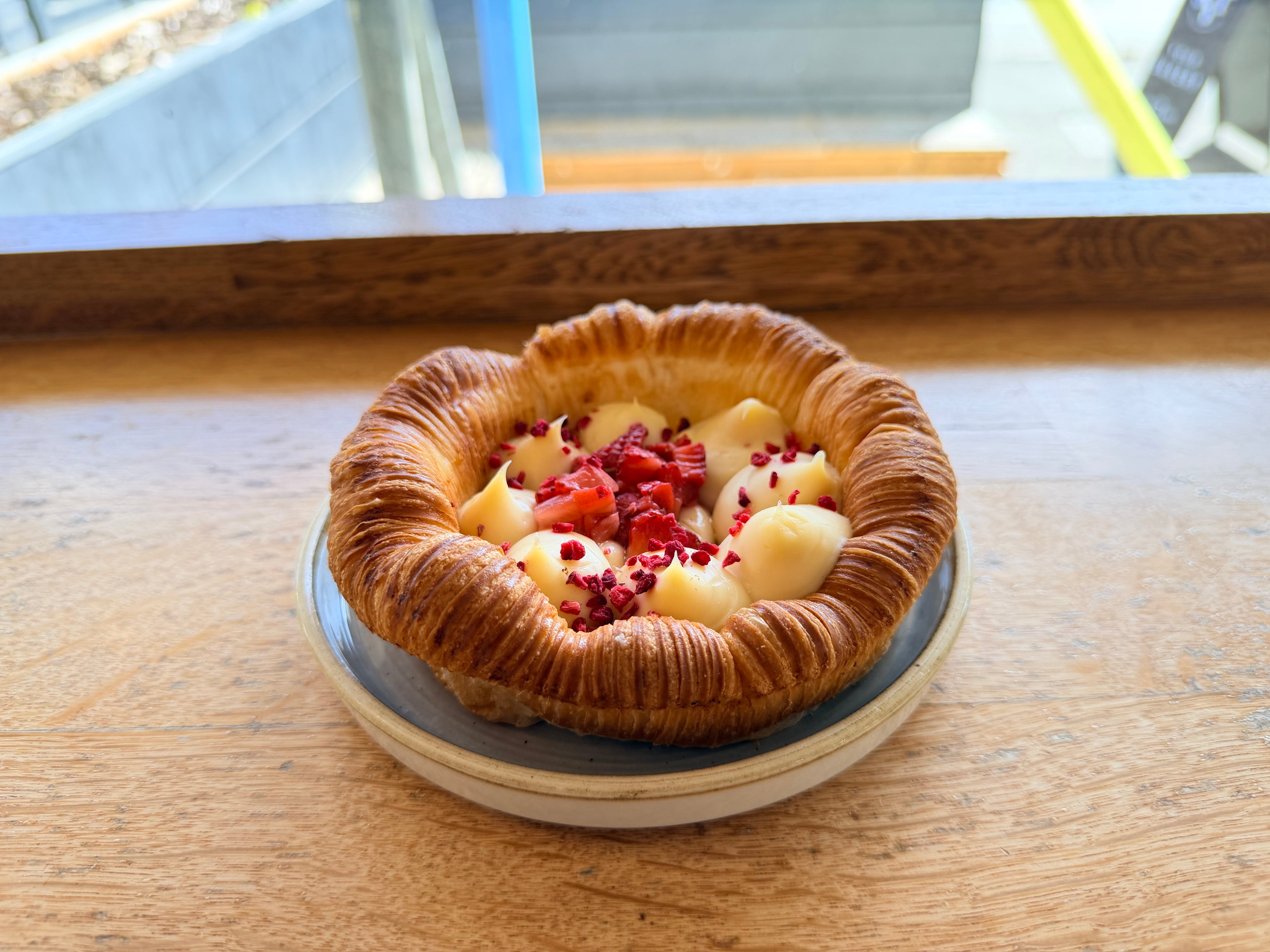 Pastries with fruit toppings on a wooden surface